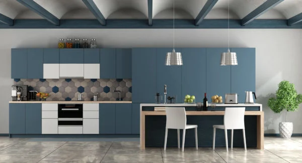 Modern kitchen with blue and white cabinets, a geometric tile backsplash, and stainless steel appliances highlights 2021 Kitchen Design Trends. An island with two white chairs sits under pendant lights, and a potted plant adds freshness on the right. Modern kitchen with blue and white cabinets, a geometric tile backsplash, and stainless steel appliances highlights 2021 Kitchen Design Trends. An island with two white chairs sits under pendant lights, and a potted plant adds freshness on the right.
