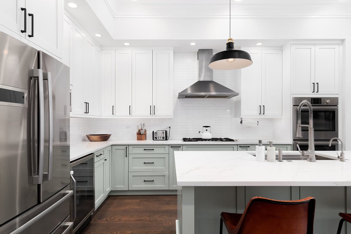 Modern kitchen with white upper cabinets, light green lower cabinets, stainless steel appliances, and a large island—a great example of contemporary Kitchen Design Layouts. The space features a gas stove with hood and is bright and well-lit. Modern kitchen with white upper cabinets, light green lower cabinets, stainless steel appliances, and a large island—a great example of contemporary Kitchen Design Layouts. The space features a gas stove with hood and is bright and well-lit.