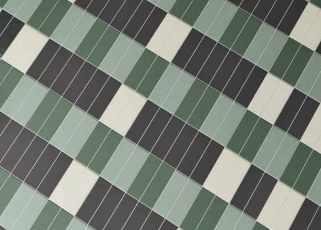 A close-up of a tiled surface, perfect for a kitchen remodel, featuring a diagonal pattern of rectangles in dark green, light green, black, and white, arranged in alternating, staggered rows. A close-up of a tiled surface, perfect for a kitchen remodel, featuring a diagonal pattern of rectangles in dark green, light green, black, and white, arranged in alternating, staggered rows.