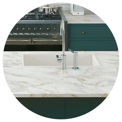 A modern kitchen remodel featuring a marble countertop, built-in sink with a chrome faucet, green cabinetry, and a stainless steel stove in the background. A modern kitchen remodel featuring a marble countertop, built-in sink with a chrome faucet, green cabinetry, and a stainless steel stove in the background.