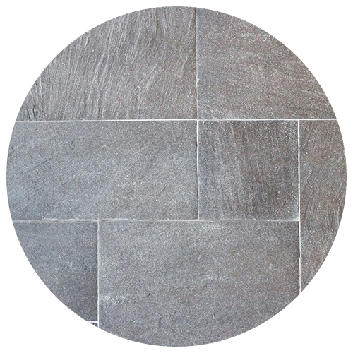 A circular image showing a pattern of rectangular gray stone tiles with visible texture and thin white grout lines between them—an elegant choice for any kitchen remodel. A circular image showing a pattern of rectangular gray stone tiles with visible texture and thin white grout lines between them—an elegant choice for any kitchen remodel.