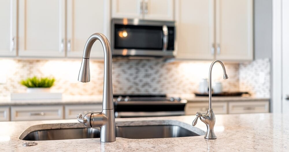 New,Modern,Faucet,And,Kitchen,Sink,Closeup,With,Island,And New,Modern,Faucet,And,Kitchen,Sink,Closeup,With,Island,And