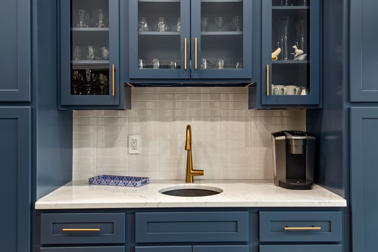 Modern kitchen countertop with coffee maker and gold faucet