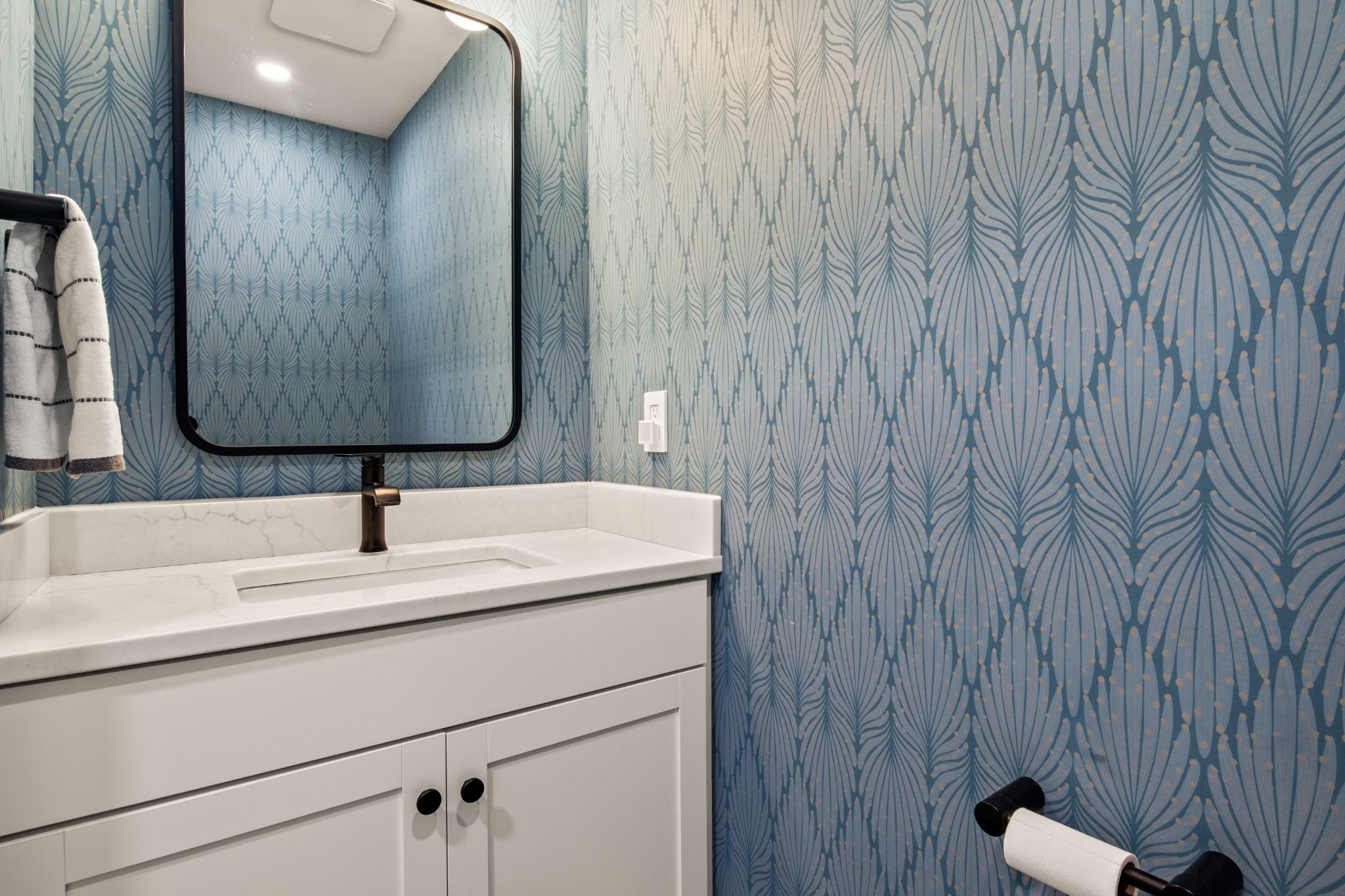 Modern bathroom interior with blue wallpaper