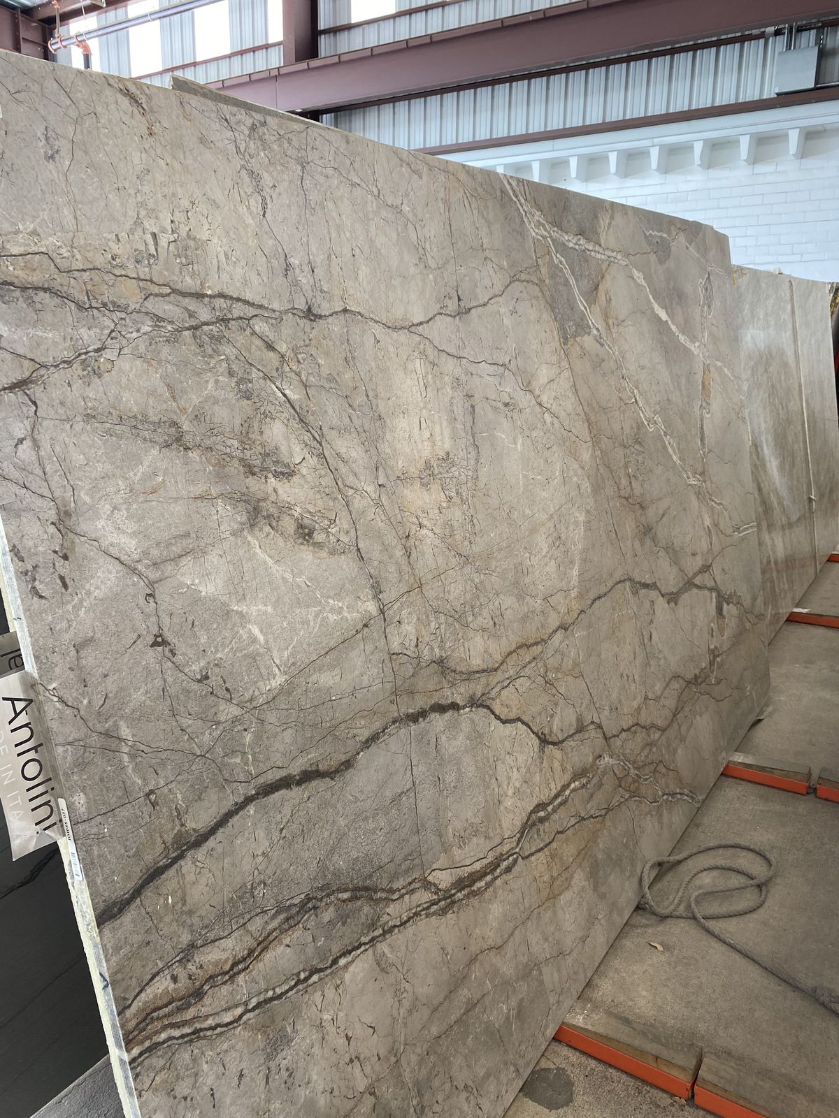 Gray marble slab with brown veins, industrial setting